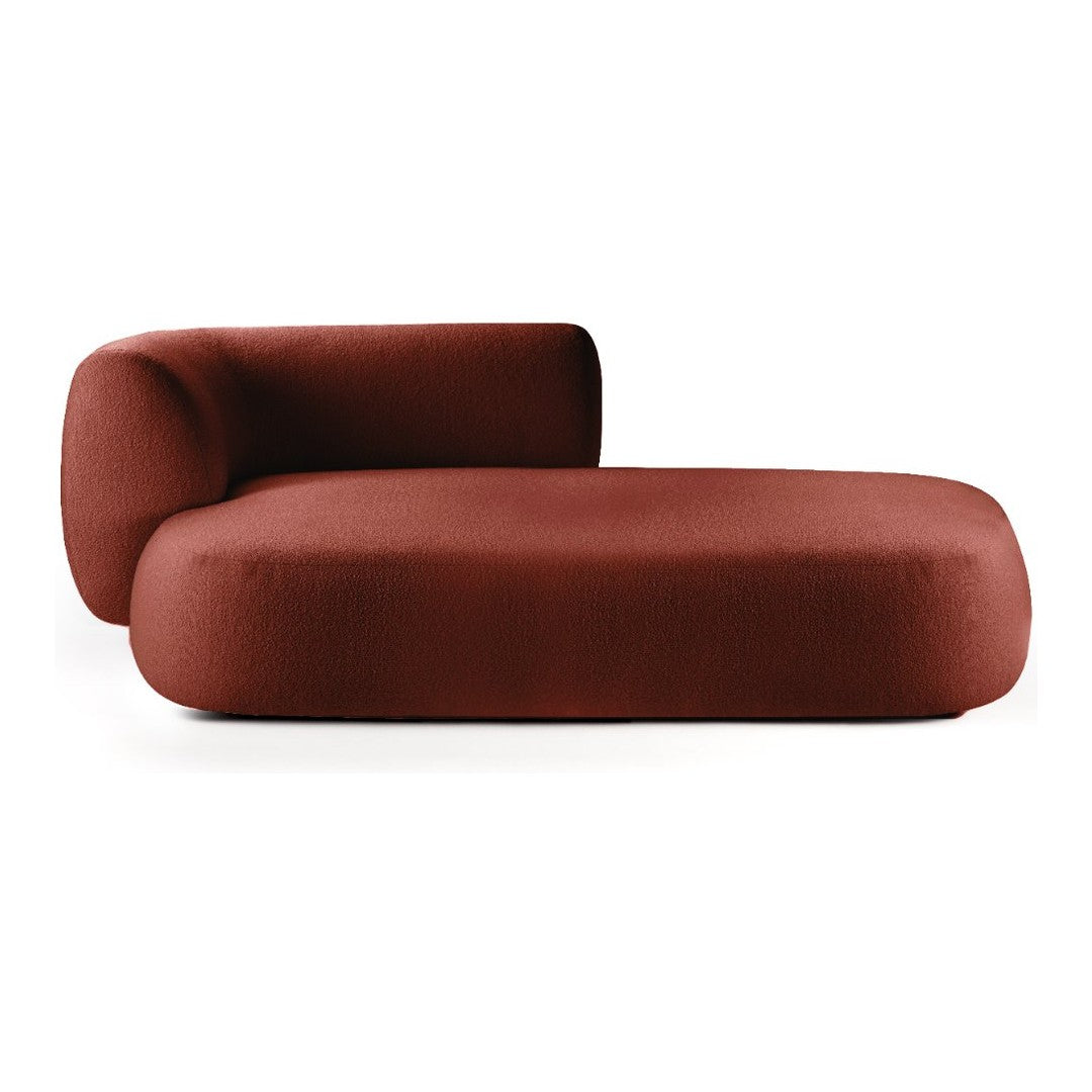 Curvy lounge chair in rich terracotta with a smooth, solid texture. Modern design with minimalist appeal.
