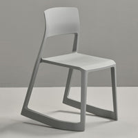 Minimalist gray chair with a sleek design and smooth surface, featuring a soft, light-hued seat.