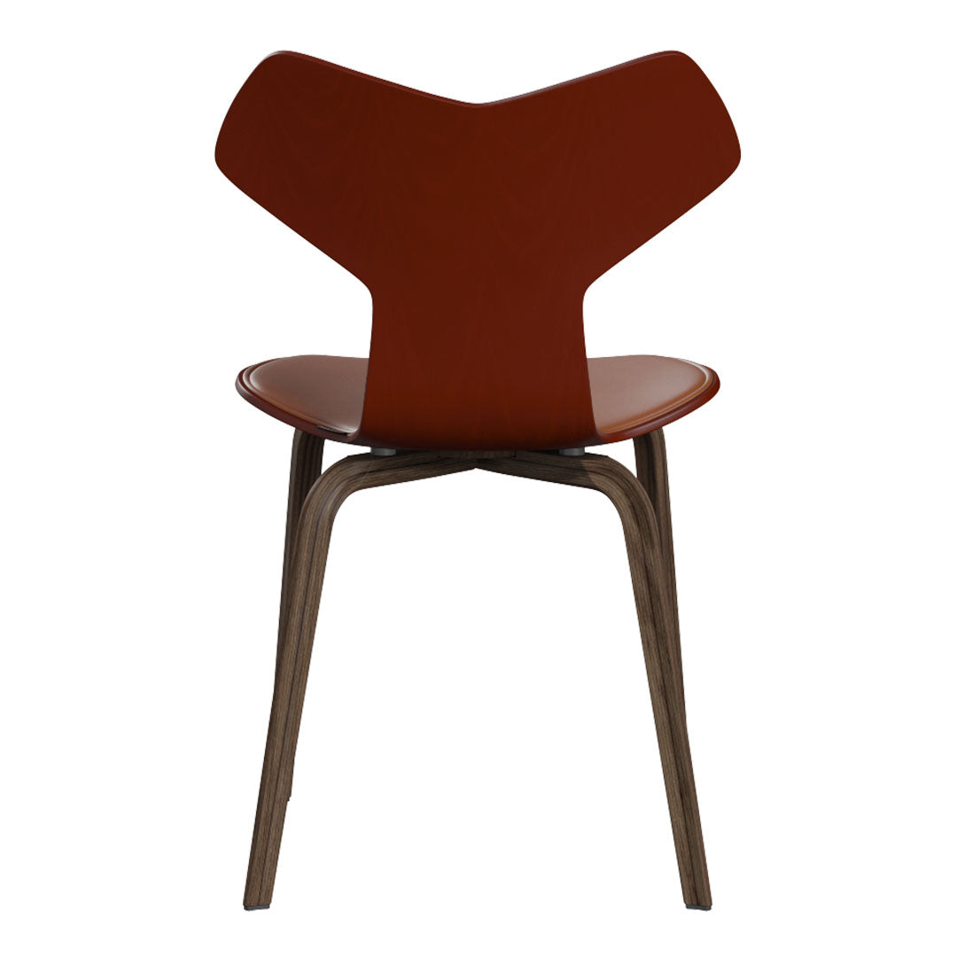 Modern chair featuring a warm brown seat and distinctive curved back, complemented by sleek wooden legs.