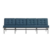 Four-seat sofa in rich navy blue with tufted cushions and a sleek black metal frame.