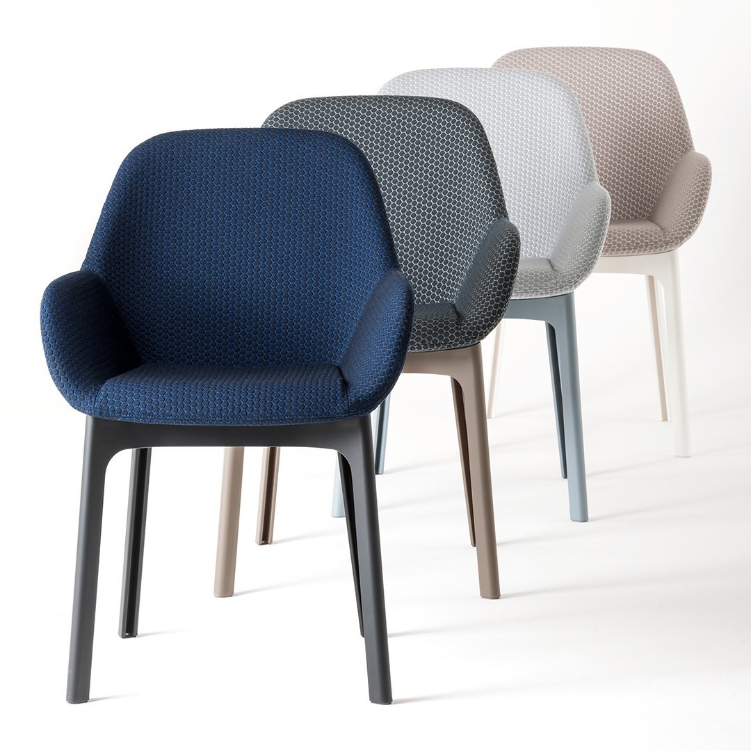 "Set of four upholstered chairs in navy, gray, light blue, and beige with textured fabric patterns."