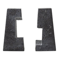 Black textured stone bookends with a modern geometric pattern, featuring cut-out shapes for a unique look.