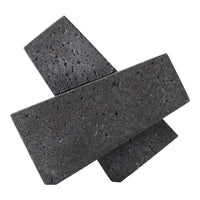 Black geometric decorative stones with a textured surface and varying angles. Elegant modern minimalist design.