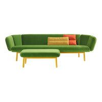 Green sofa with yellow legs, featuring orange, yellow, and red accent pillows on a sleek design.