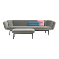 Modern gray sofa with pastel pink and blue cushions, featuring sleek lines and minimalist design.
