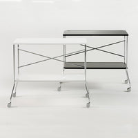 "Modern metal rolling carts in sleek black and white with minimalist design and clear glass shelves."