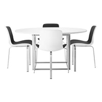Round white dining table with black and white patterned chairs, featuring sleek silver legs for modern appeal.