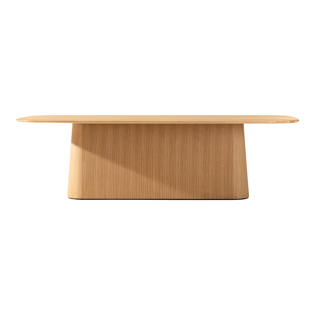 Light oak wood table with a sleek, minimal design and a smooth surface featuring subtle, natural grain patterns.
