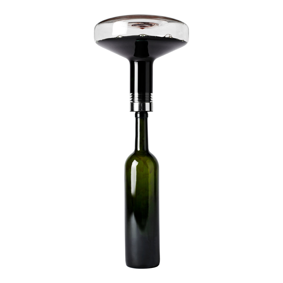 Glossy black aerator with a clear top over a deep green glass bottle, featuring sleek modern design and elegant style.