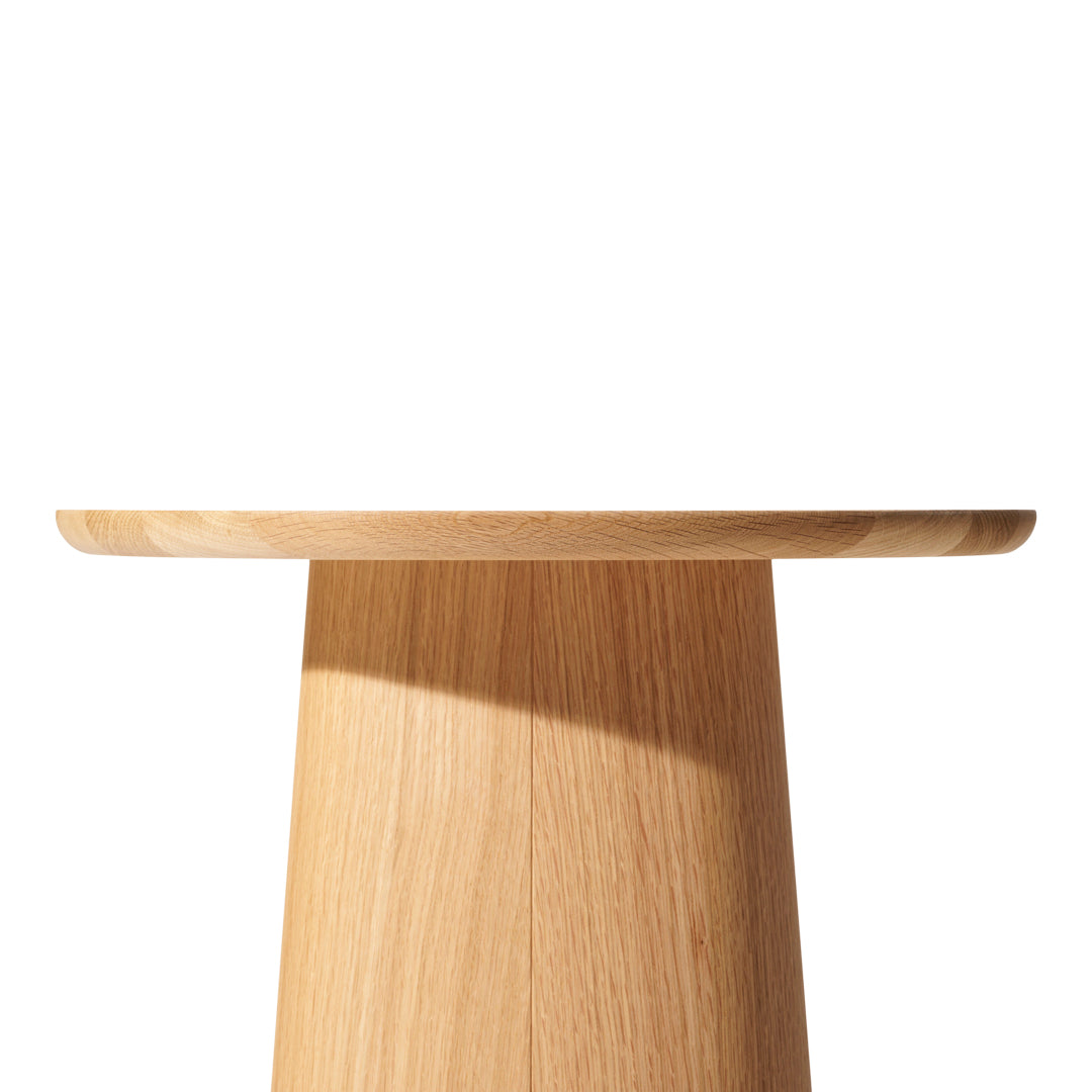 Natural oak table with a smooth, warm wood grain and light tan finish, showcasing a minimalist design.