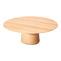 Light wood round coffee table with smooth, natural grain pattern and a minimalist pedestal base.