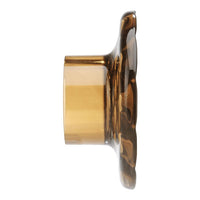 Amber-colored glass candle holder with a floral pattern, featuring a smooth, glossy finish.