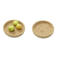 Natural cork round plates featuring a textured, light brown surface, perfect for showcasing fruits and snacks.