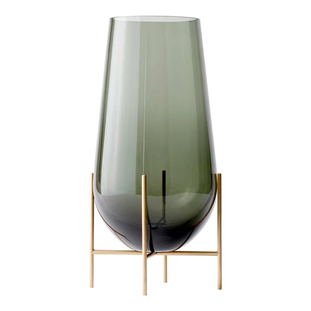 Green tinted glass vase with a sleek design, featuring a smooth finish and mounted on a stylish gold stand.