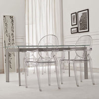 Clear acrylic dining table and chairs set against a light, soft-toned background with minimalistic decor.
