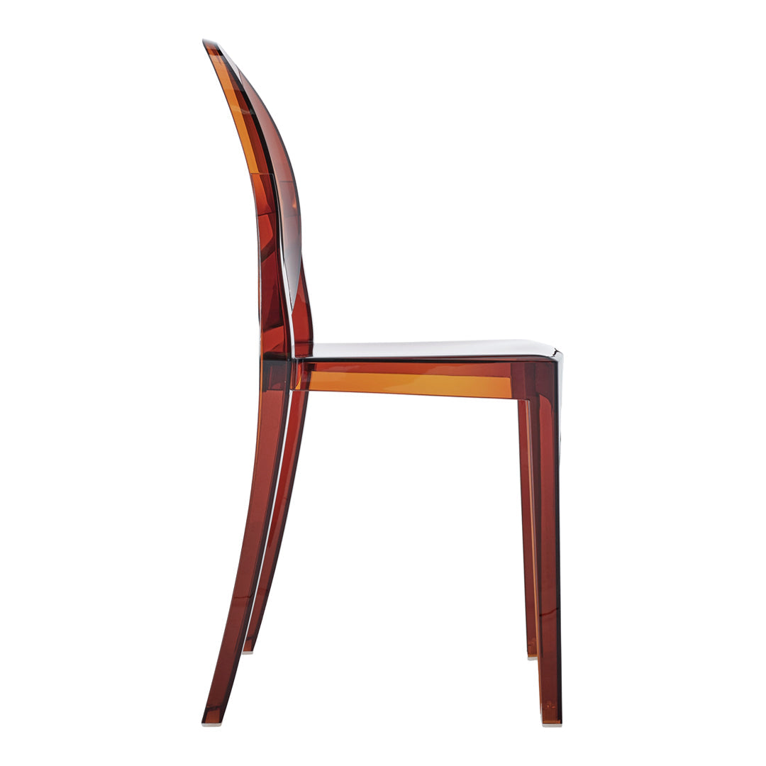 Transparent amber chair with smooth curves and a glossy finish, showcasing rich, warm tones.