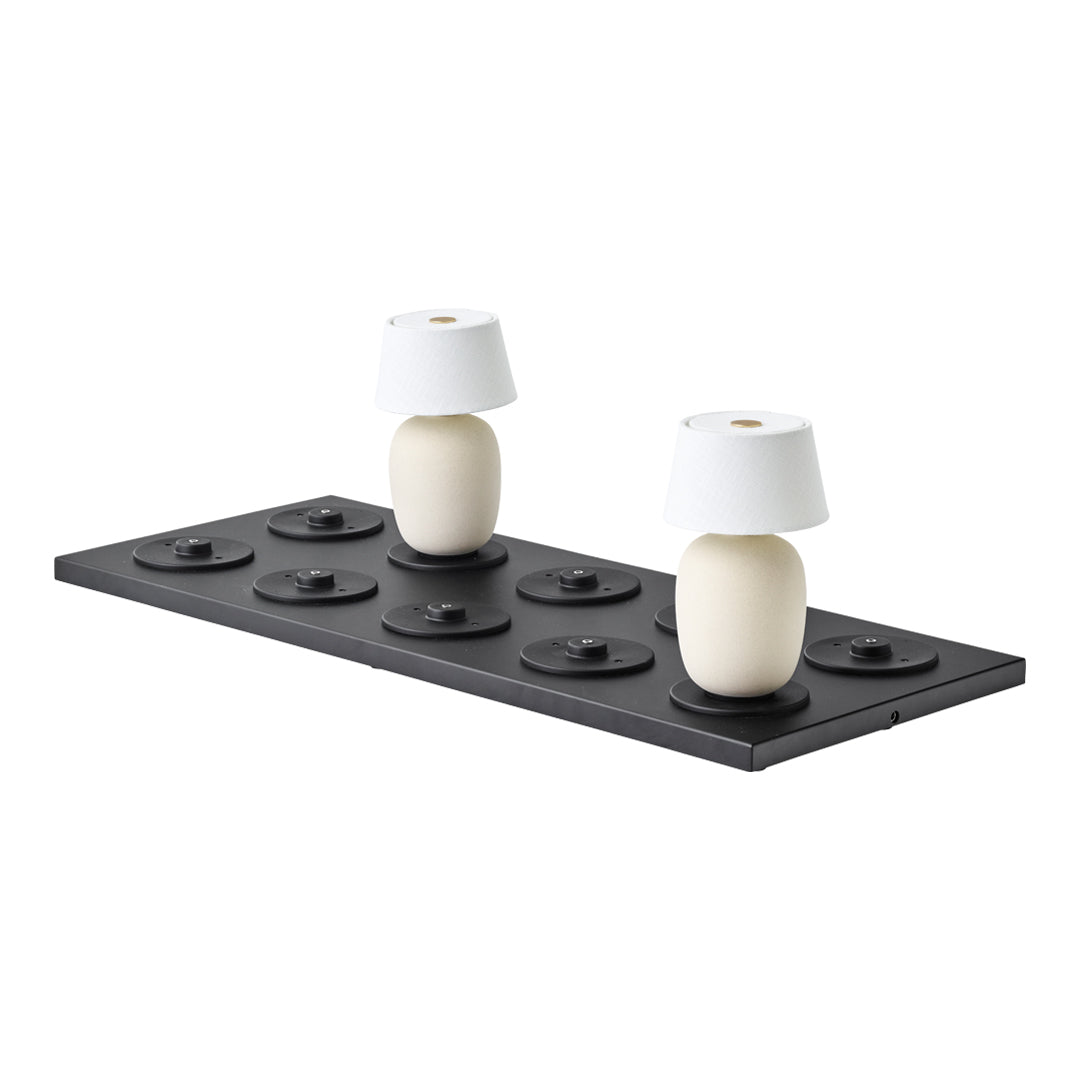 Black base with circular patterns, featuring two white lamps with conical shades. Minimalist and modern design.