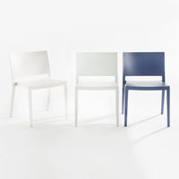Set of three modern chairs in white, light gray, and navy blue with sleek, minimalistic design.