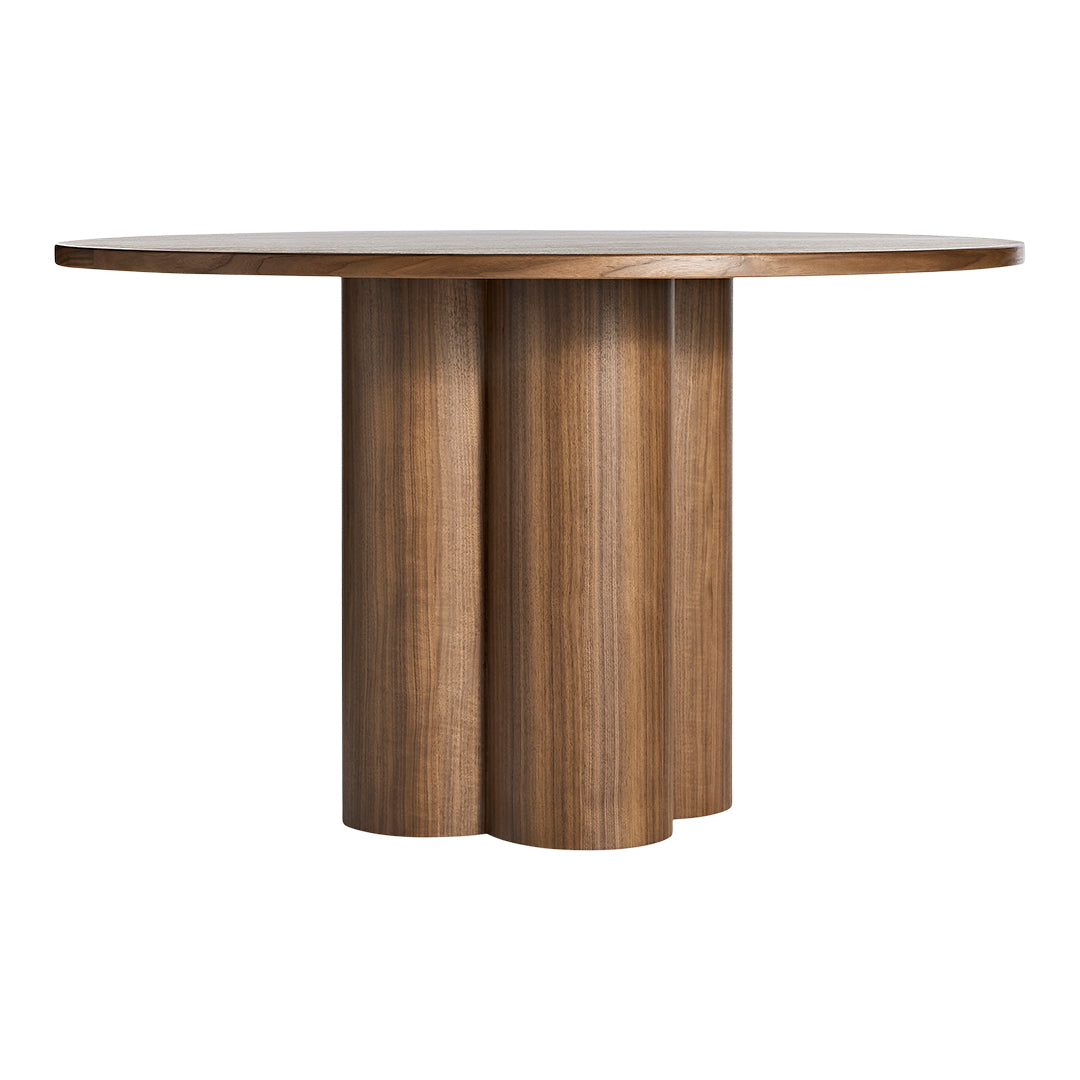 Round wooden table with a natural wood finish and textured, curved pedestal base. Perfect for modern dining spaces.