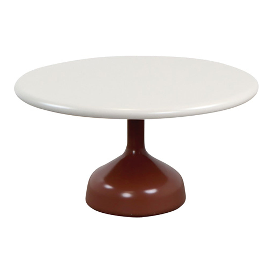 Round table with a sleek white top and a stylish brown pedestal base. Modern design in a minimalist color palette.