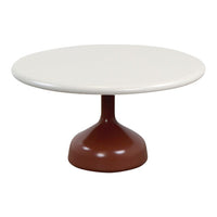 Round table with a sleek white top and a stylish brown pedestal base. Modern design in a minimalist color palette.