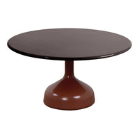 Round brown dining table with a smooth surface and a pedestal base, featuring a sleek, modern design.