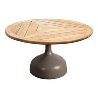 Round coffee table with a natural wood top featuring a geometric pattern, set on a sleek gray pedestal base.