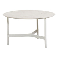 Round coffee table with a textured light beige top and a matte white base, featuring minimalist design.