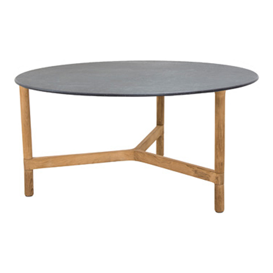Round table with a sleek dark gray top and natural wood legs, highlighting a modern and minimalist aesthetic.