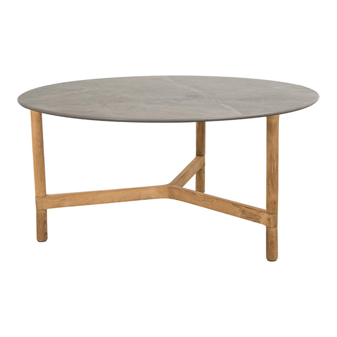 Round table with a smooth gray top and natural wood legs, featuring a minimalist design and contemporary style.