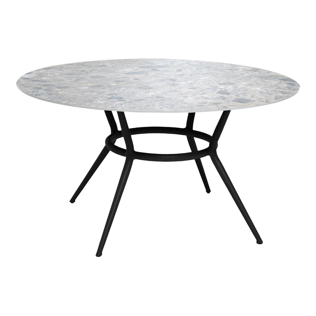 Round marble dining table with a grey and white patterned top and sleek black metal legs. Perfect for modern decor.