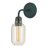 Sleek glass wall sconce with a green metal arm, featuring a warm amber filament bulb for a vintage look.