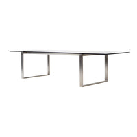 Rectangular glass table with a sleek silver metal frame, featuring a minimalist design and clean lines.