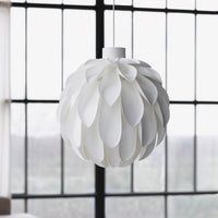White pendant light featuring layered petal design, creating an elegant, modern look with a sleek finish.