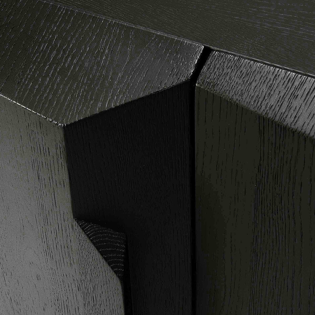 Black wood cabinet featuring a textured finish and geometric patterns. Elegant and modern design aesthetic.