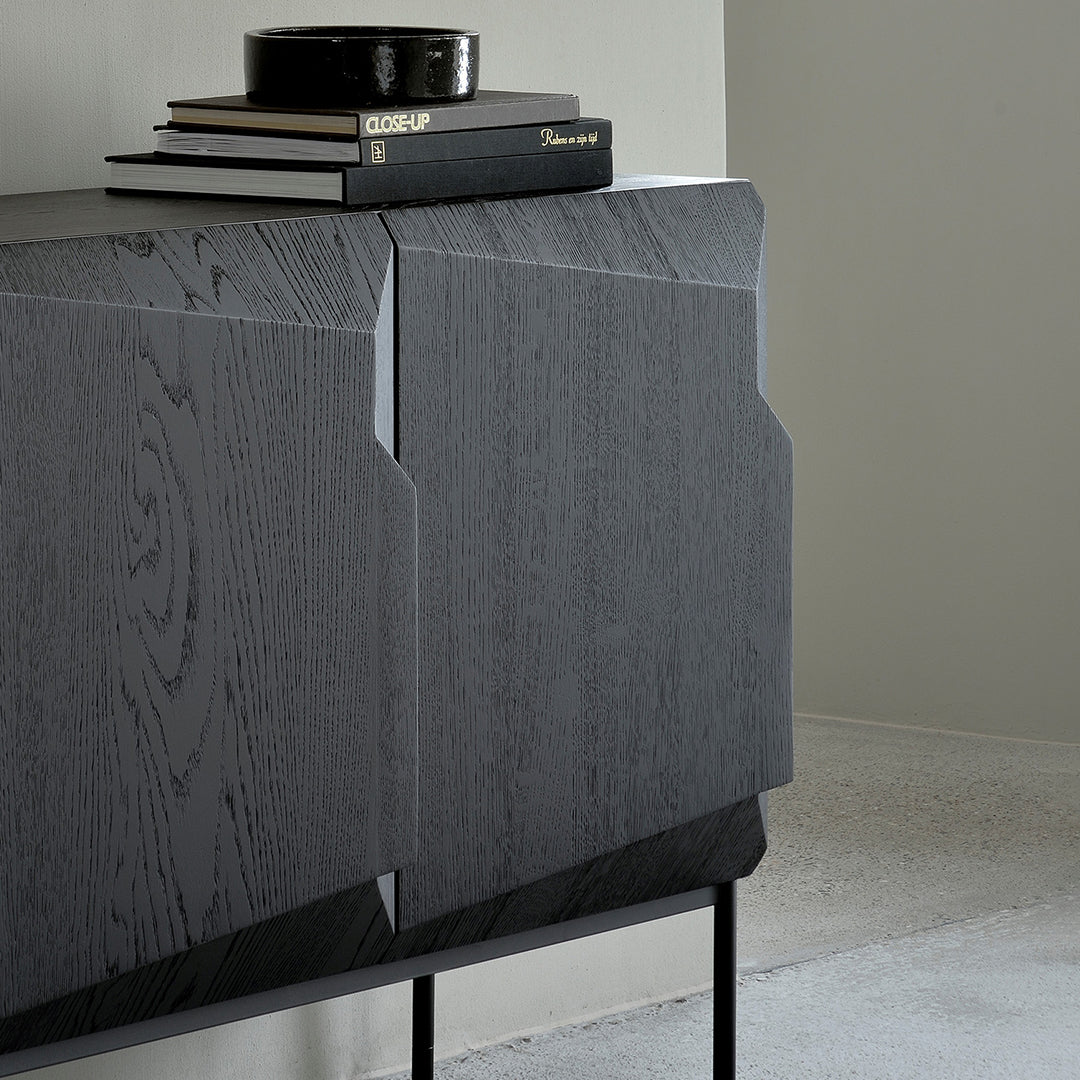 Modern dark wood sideboard with textured gray finish and sleek black metal legs, featuring minimalist geometric patterns.