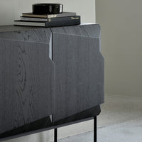 Modern dark wood sideboard with textured gray finish and sleek black metal legs, featuring minimalist geometric patterns.