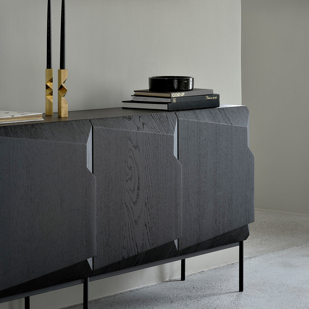 Elegant dark wood sideboard with subtle grain patterns, paired with sleek black and gold decorative accents.