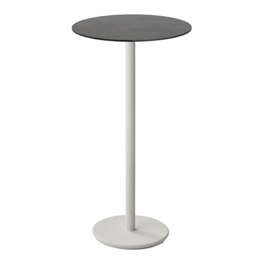 Round table with a sleek black top and a minimalist white base, perfect for modern decor.