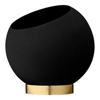 Black ceramic bowl with a sleek gold base, featuring a modern, minimalist design.