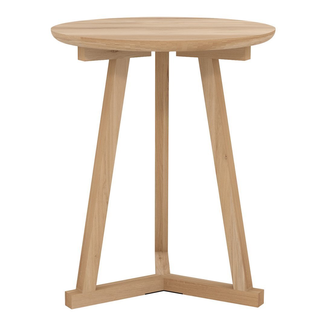 Light natural wood side table with a smooth round top and minimalist angular legs, showcasing a modern, neutral aesthetic.