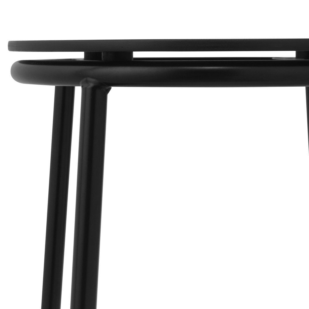 Black metal table with a sleek, minimalist design and simple geometric lines. Perfect for modern decor.