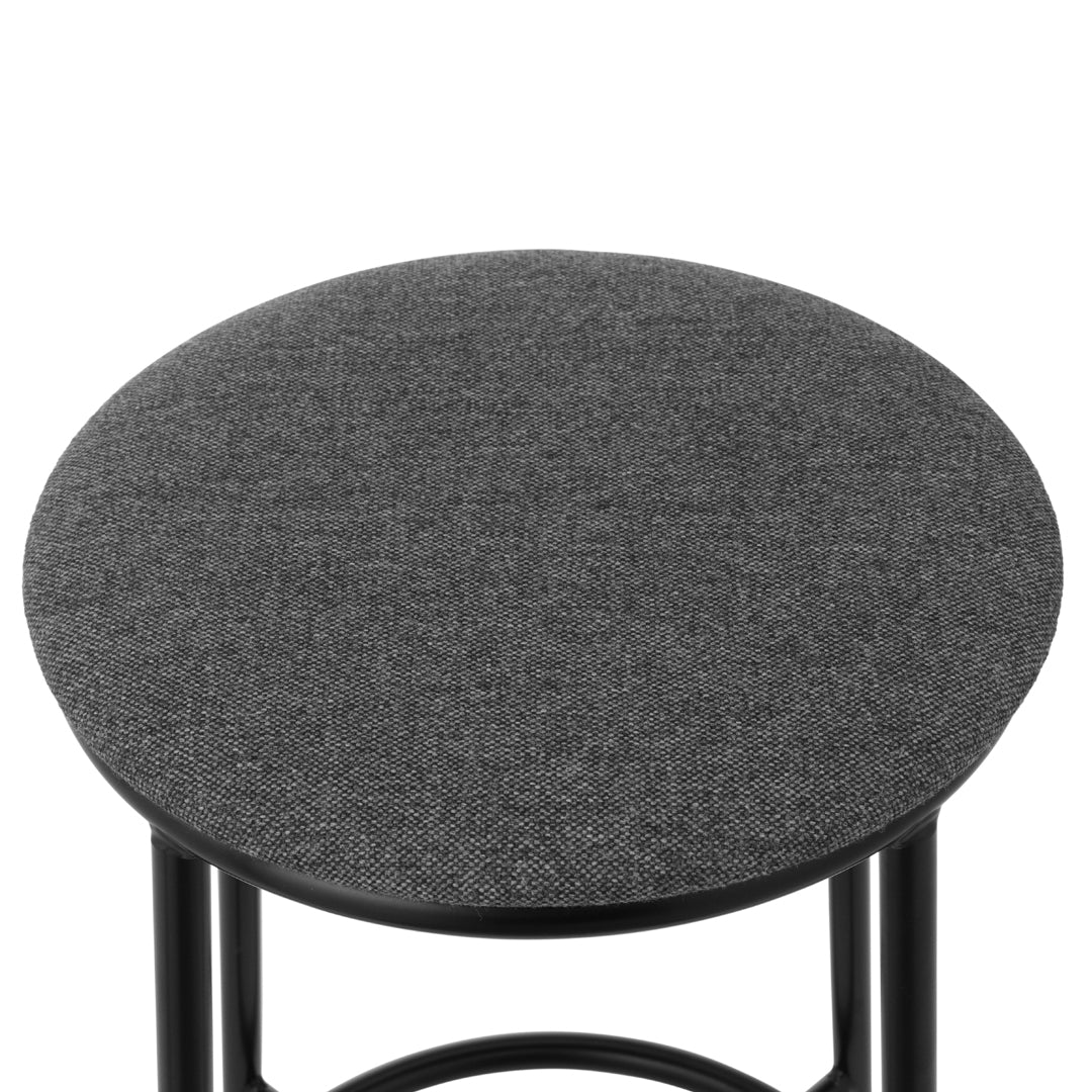 Round stool with a textured dark gray fabric seat and a simple black metal frame. Modern and minimalist design.