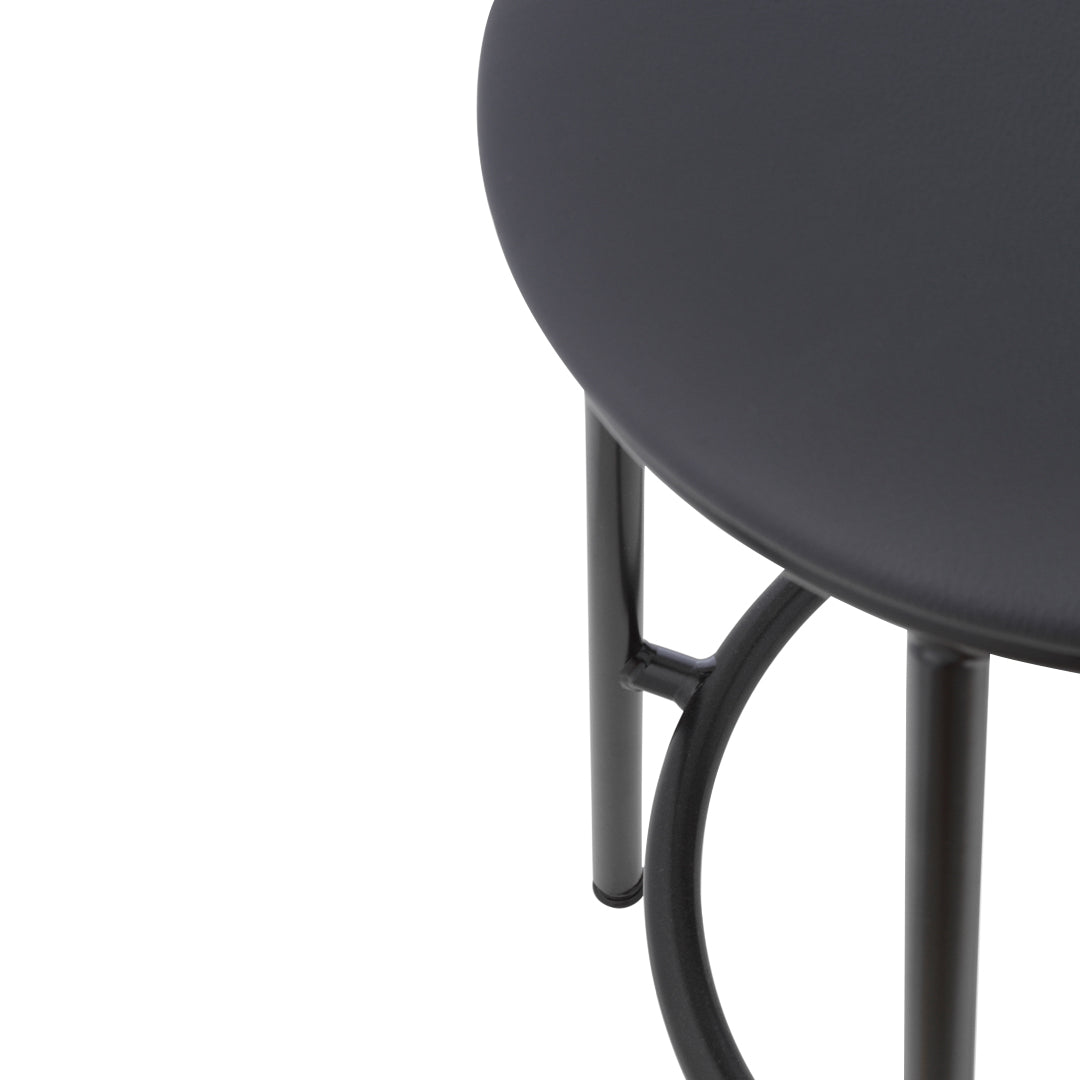 Sleek black round tabletop with minimalist black metal legs, showcasing a modern design.