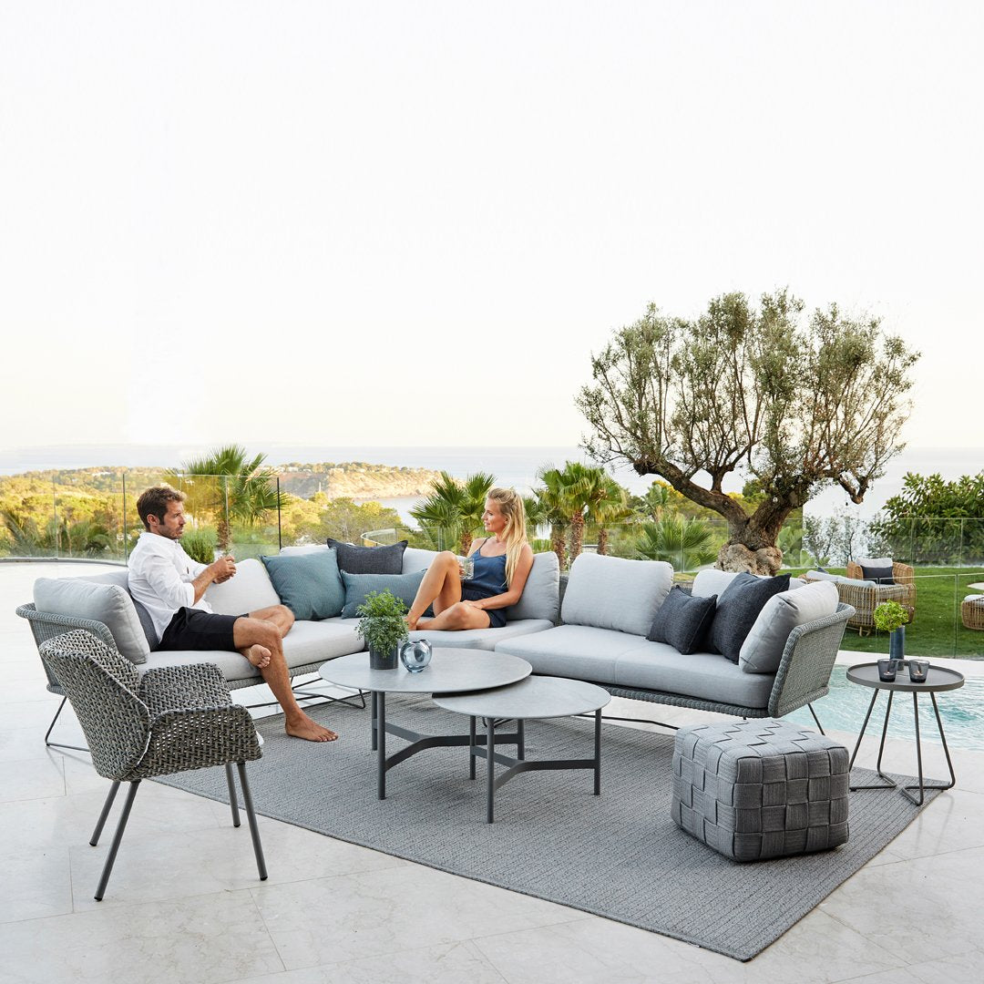 Sleek gray outdoor sofa set with plush cushions and a stylish patterned area rug, perfect for modern patio decor.