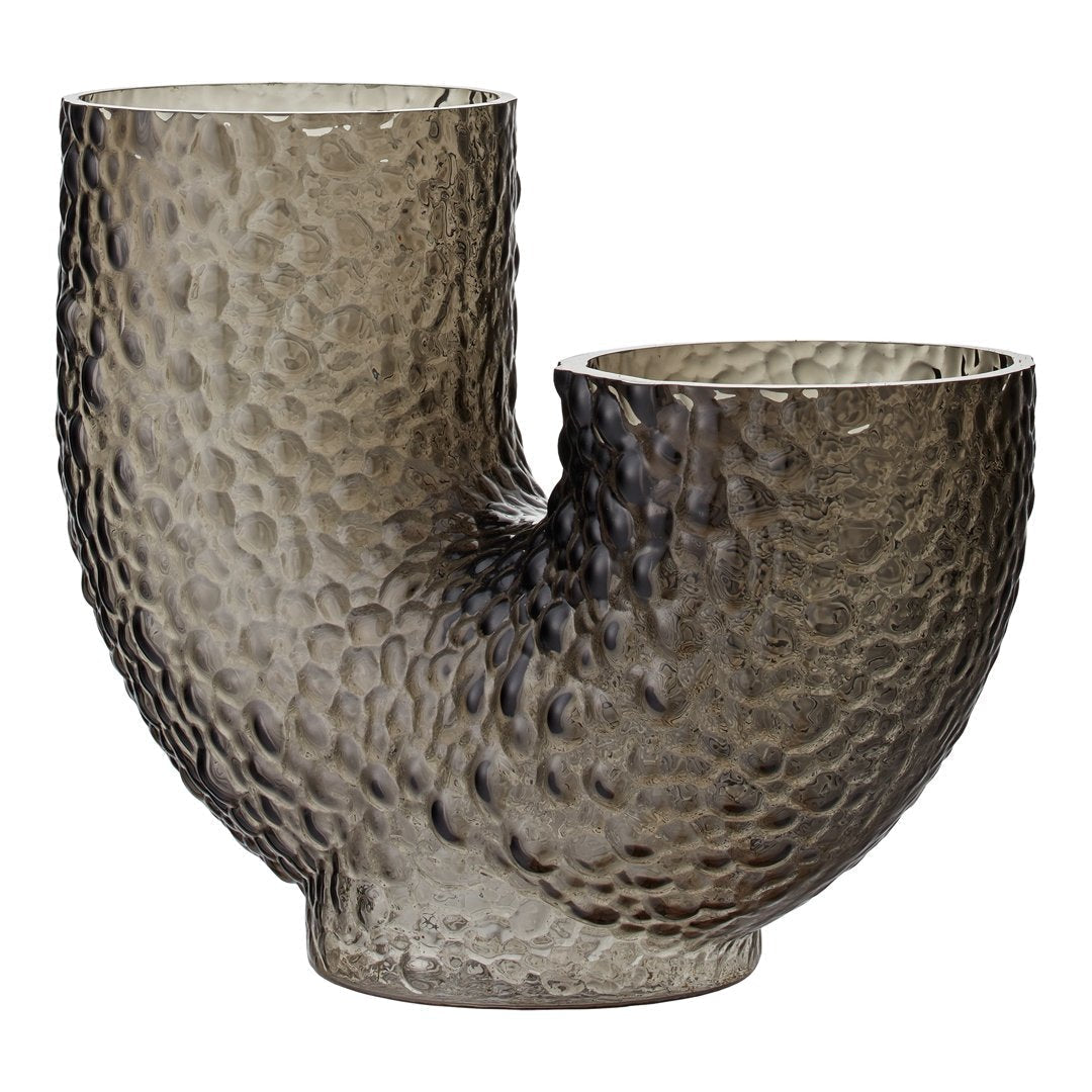 Textured glass vase in smoky gray with a unique abstract shape and ribbed pattern, perfect for modern decor.
