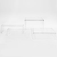 Clear acrylic nesting tables with a minimalist design, showcasing a sleek, transparent finish and angular shapes.