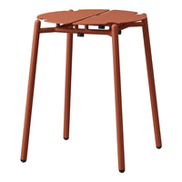 Rust-colored stool with a modern, minimalist design, featuring a unique leaf-shaped pattern on the top.