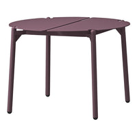 "Round, split-top table in deep burgundy with a minimalist design and smooth matte finish."