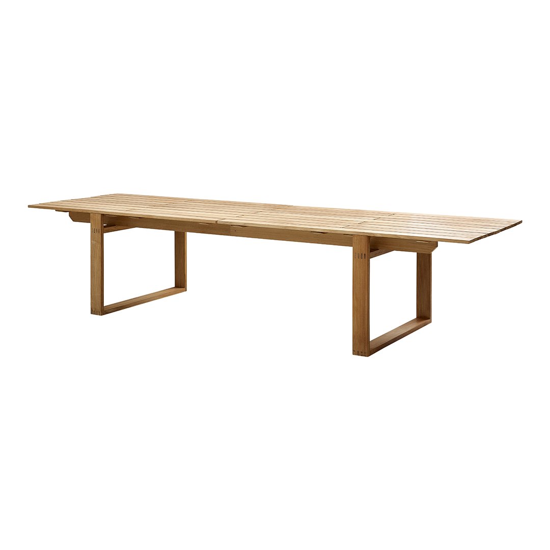 Natural wood finish dining table with smooth, light oak surface and minimalist rectangular design.